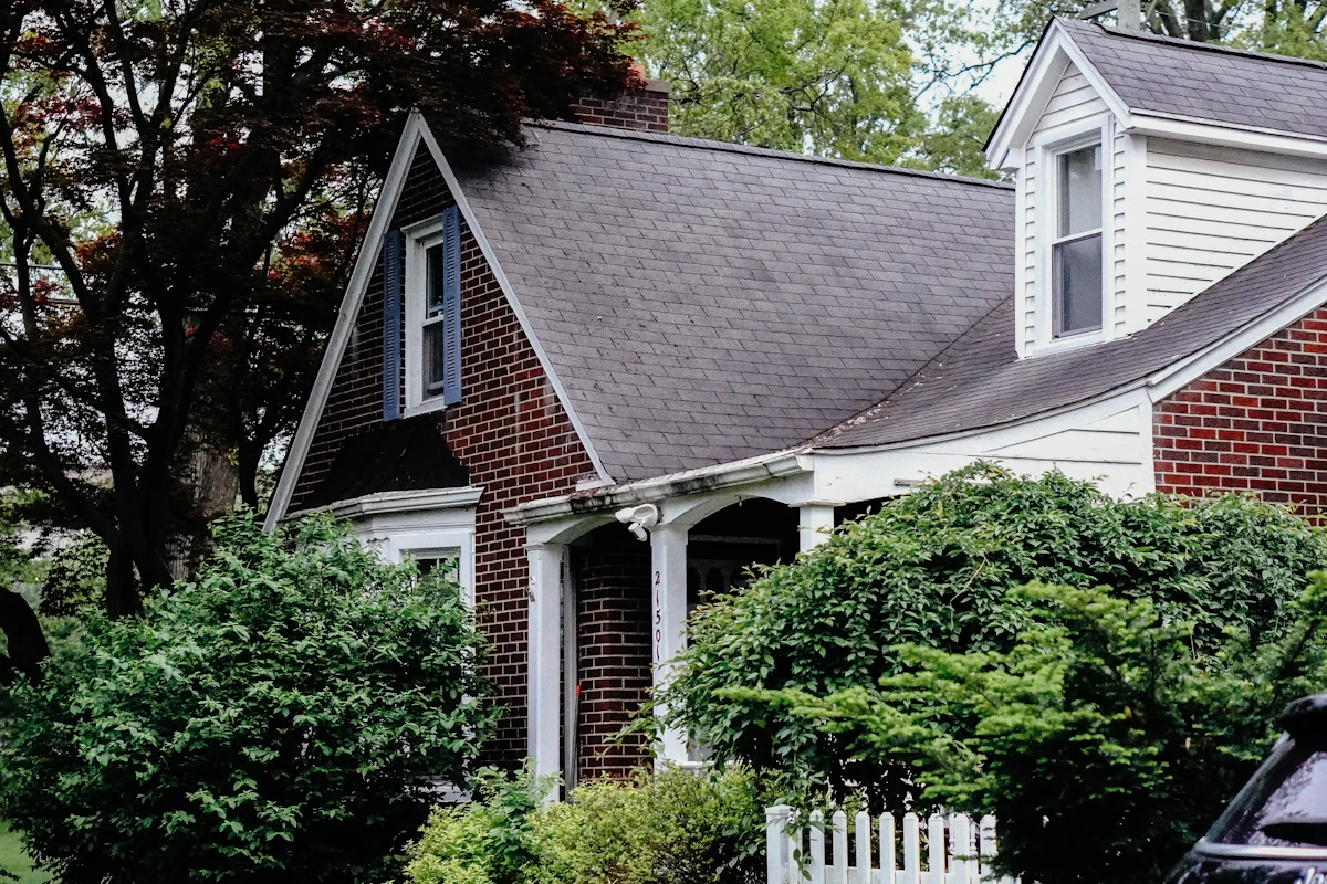 House with a dormer roof and shrubbery