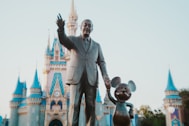 Walt disney and mickey mouse stand together.