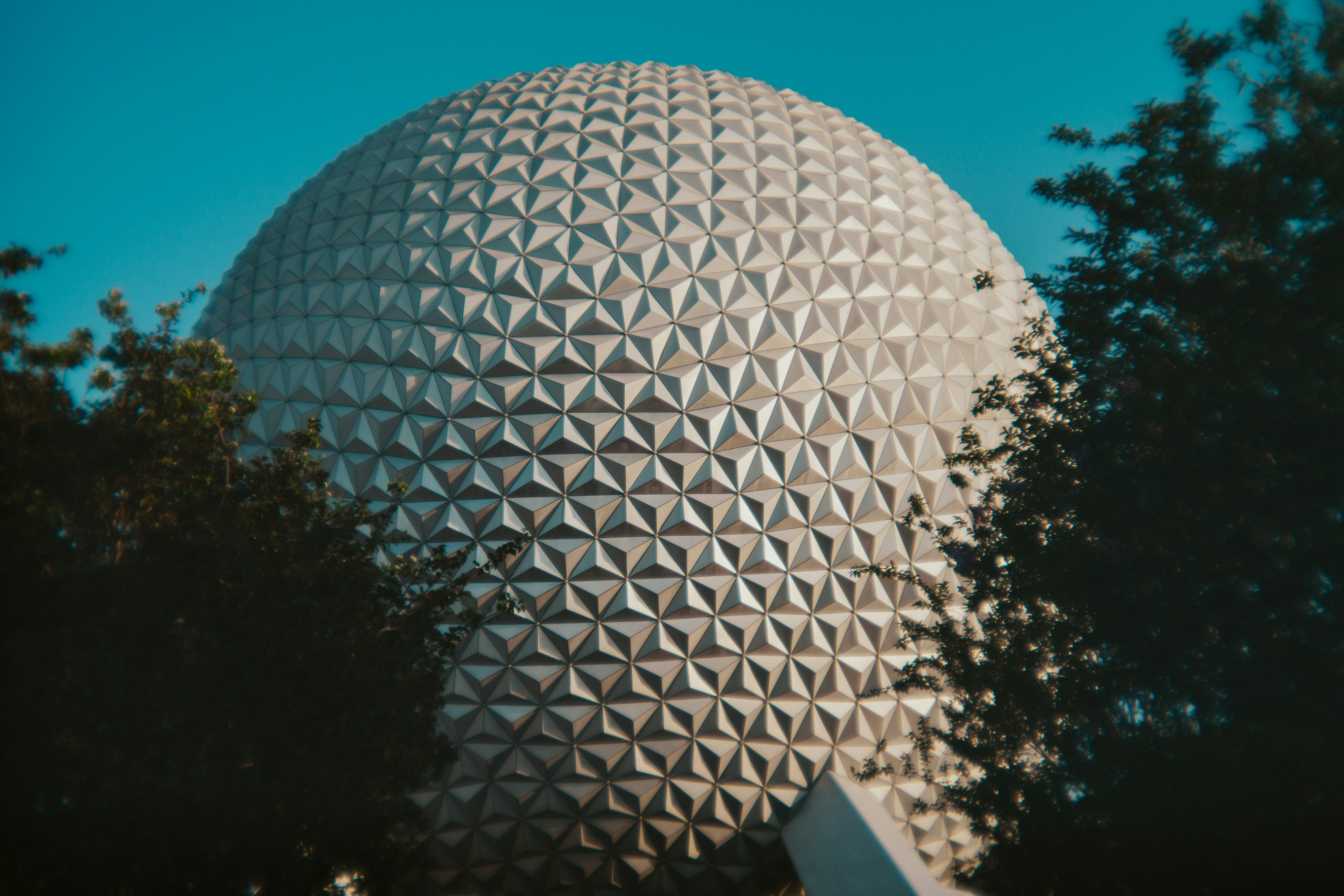 Spaceship earth at epcot park towers in view.