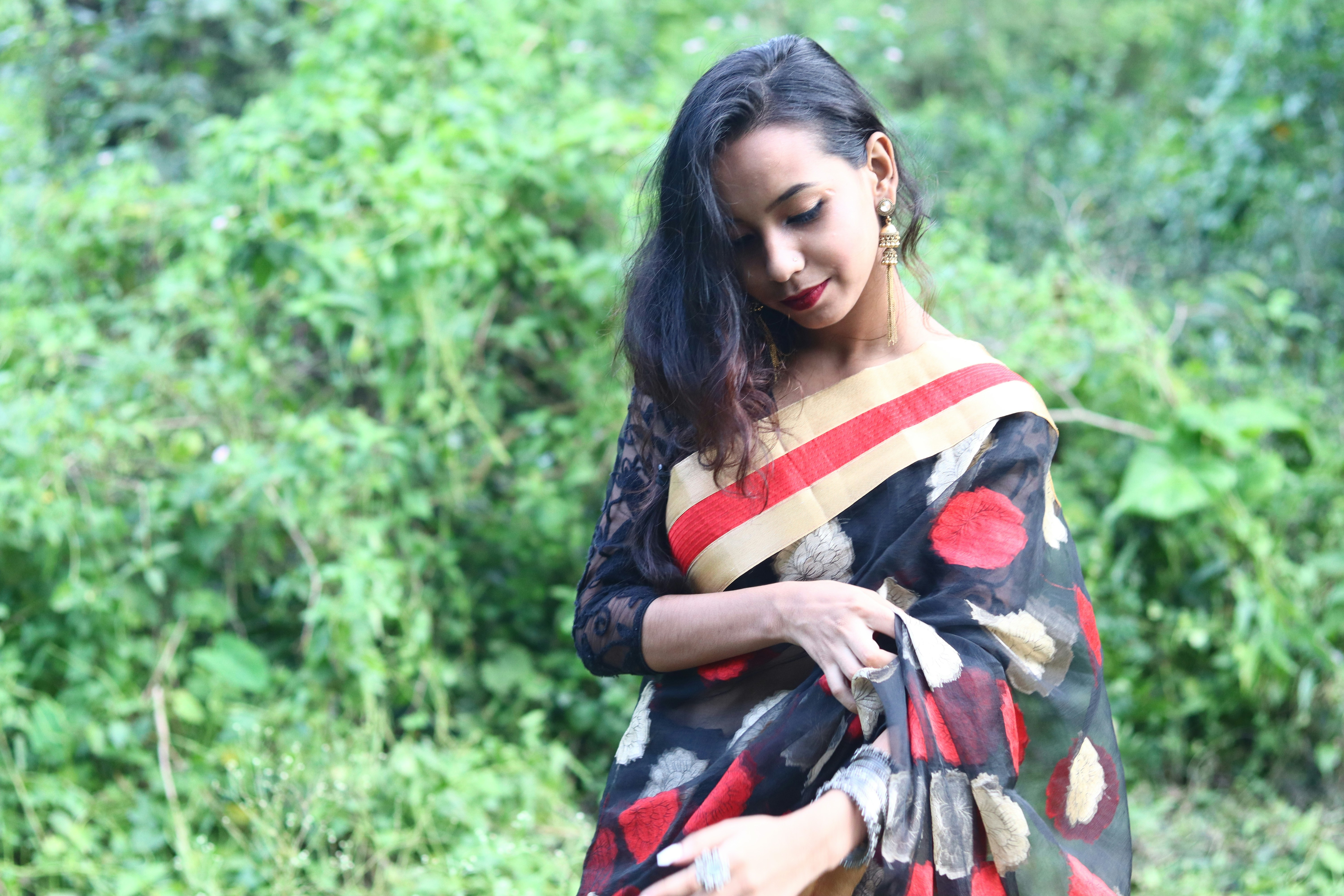 Woman in a sari poses for a photo.