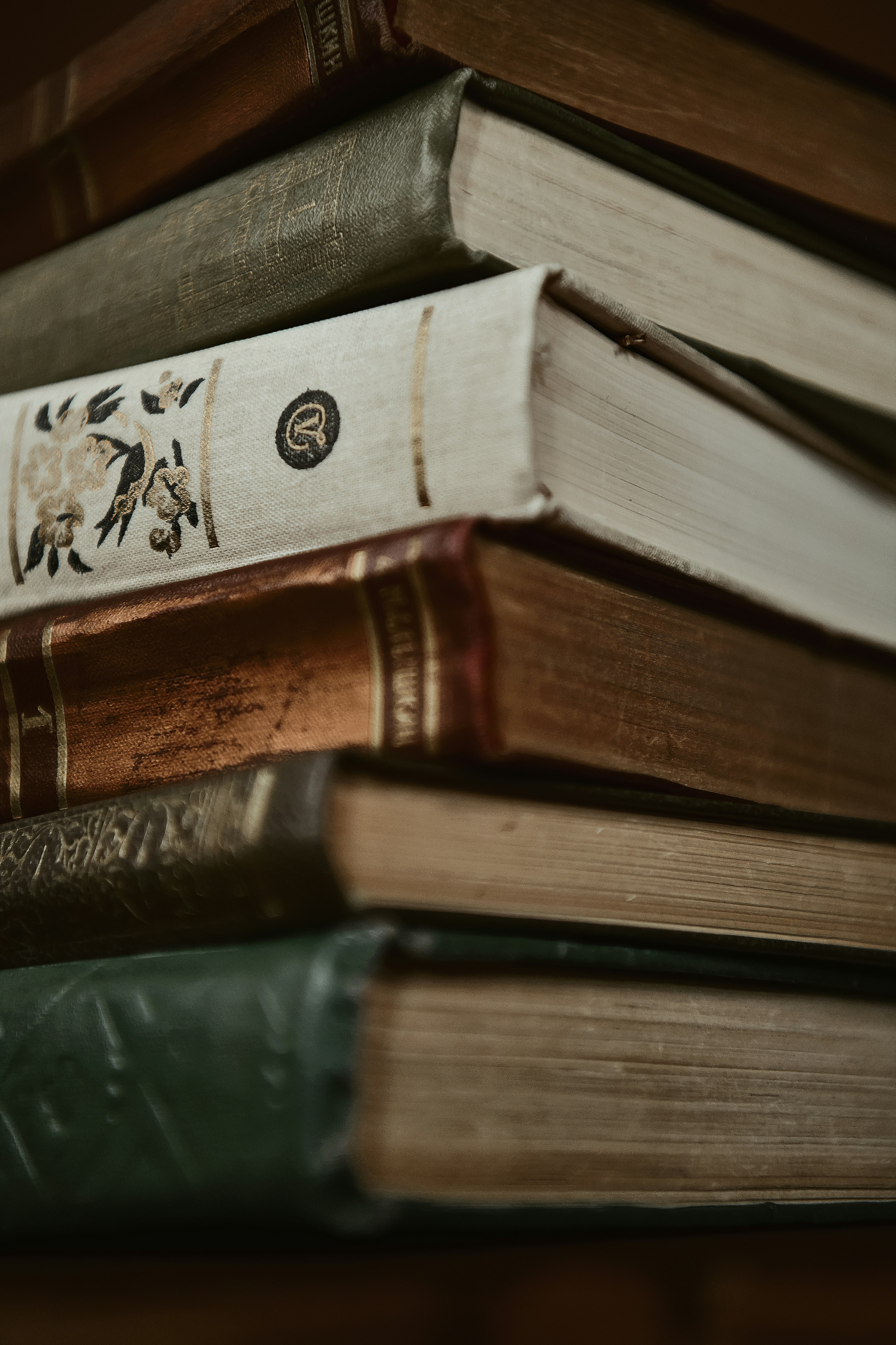 A stack of antique books in close-up.