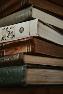 A stack of antique books in close-up.
