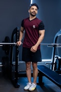 Fit man poses in a gym.