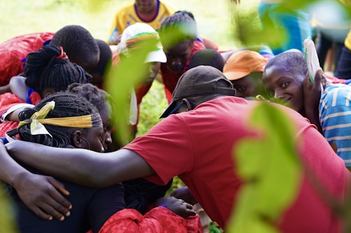 People of diverse backgrounds share a warm embrace.