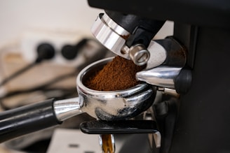Coffee grounds are being poured into a portafilter.