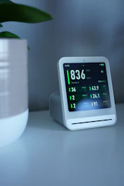 Air quality monitor displays pollution readings on a screen.