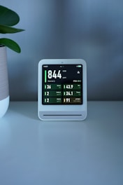 Air quality monitor displaying various readings.