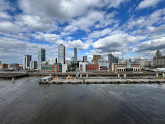 City skyline with a cloudy, blue sky above