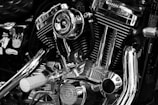 Shiny motorcycle engine details in black and white.