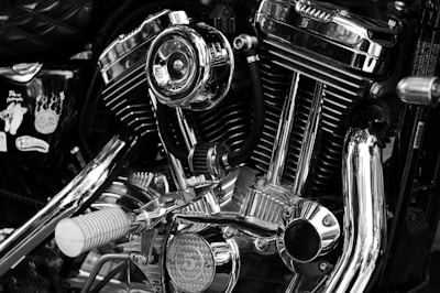 Shiny motorcycle engine details in black and white.