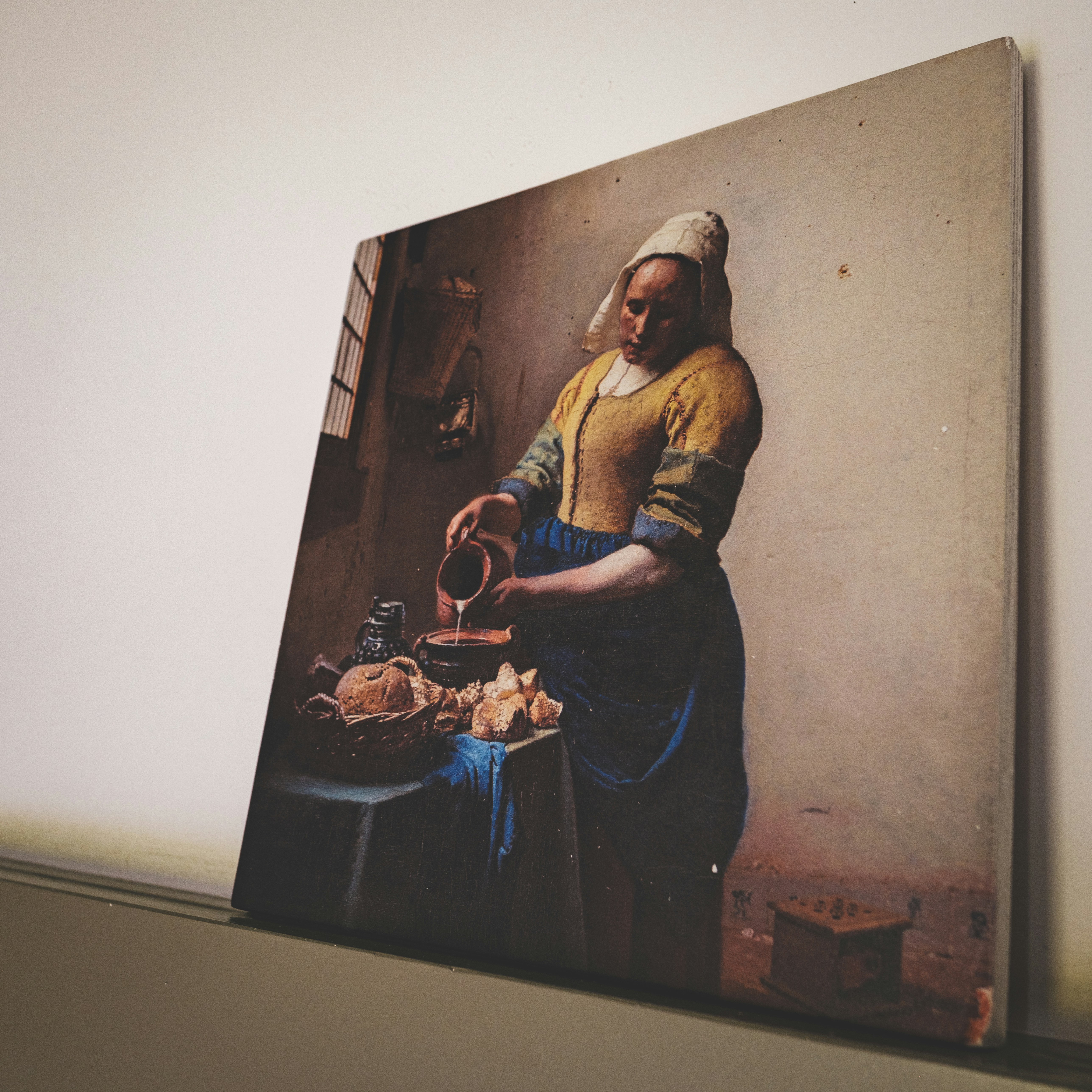 A canvas displays vermeer's "the milkmaid."