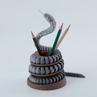 A snake pencil holder with pencils.