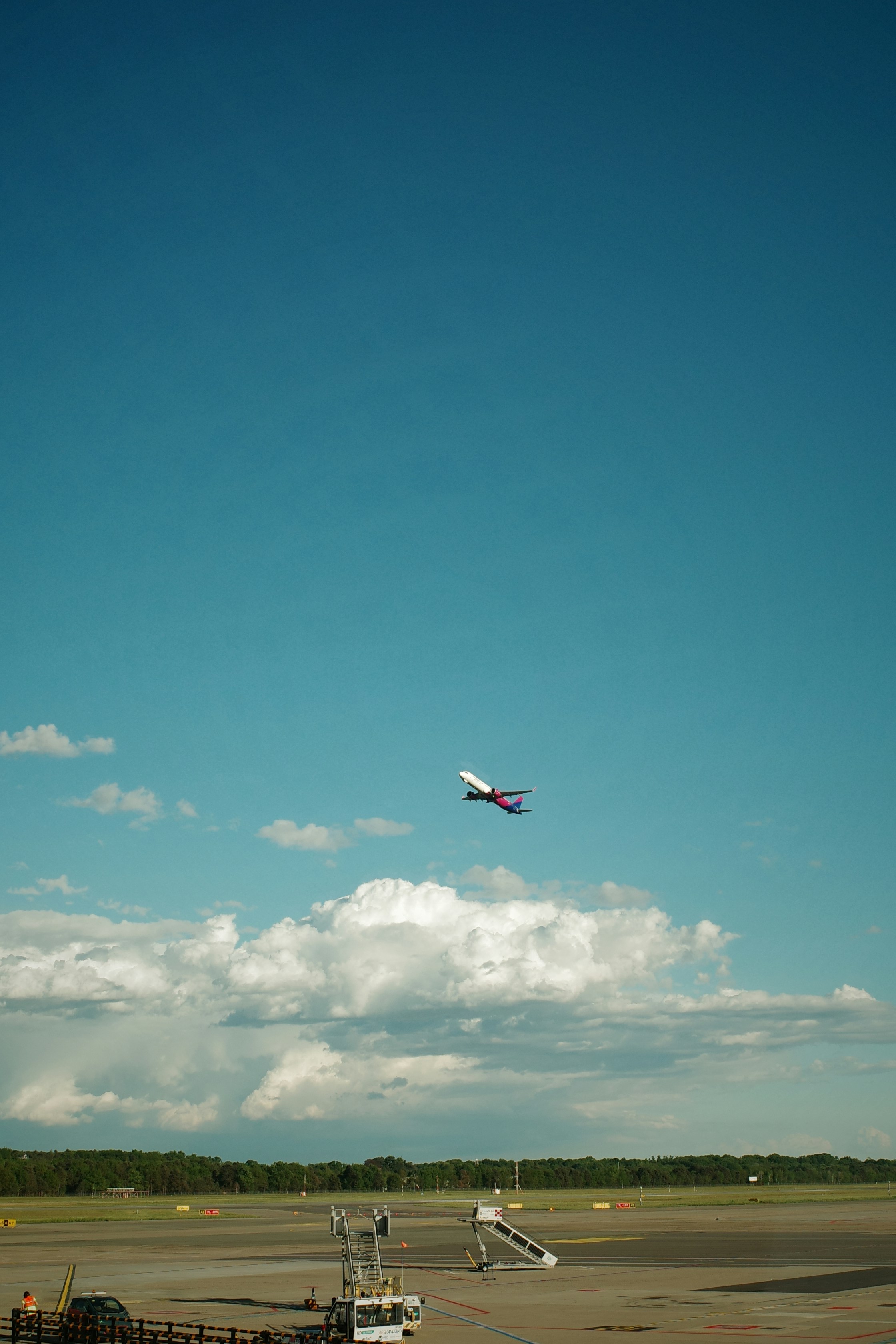 An airplane is taking off into a blue sky.
