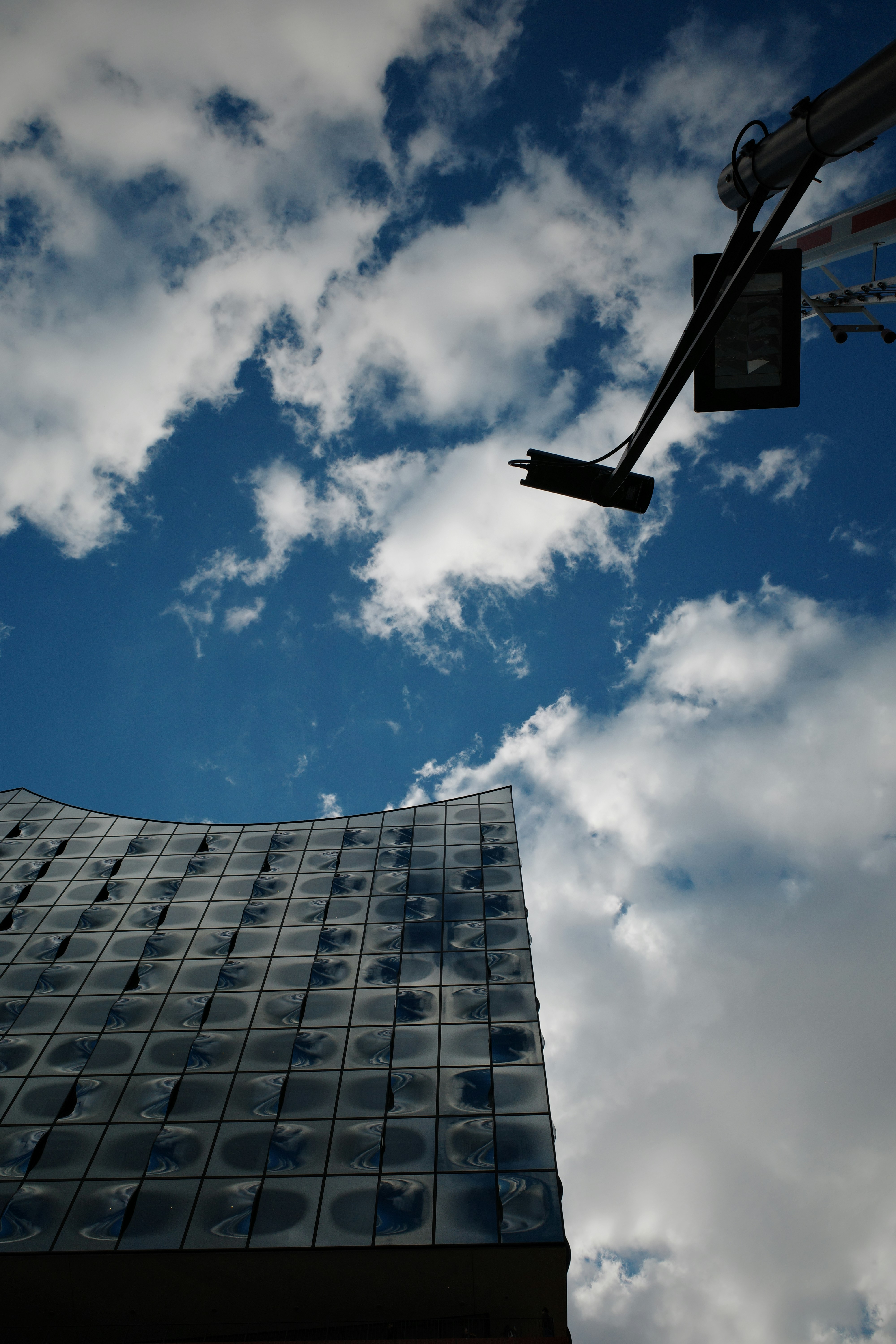 A building against a blue sky with clouds.