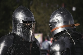 Two knights stand, armored and prepared for battle.