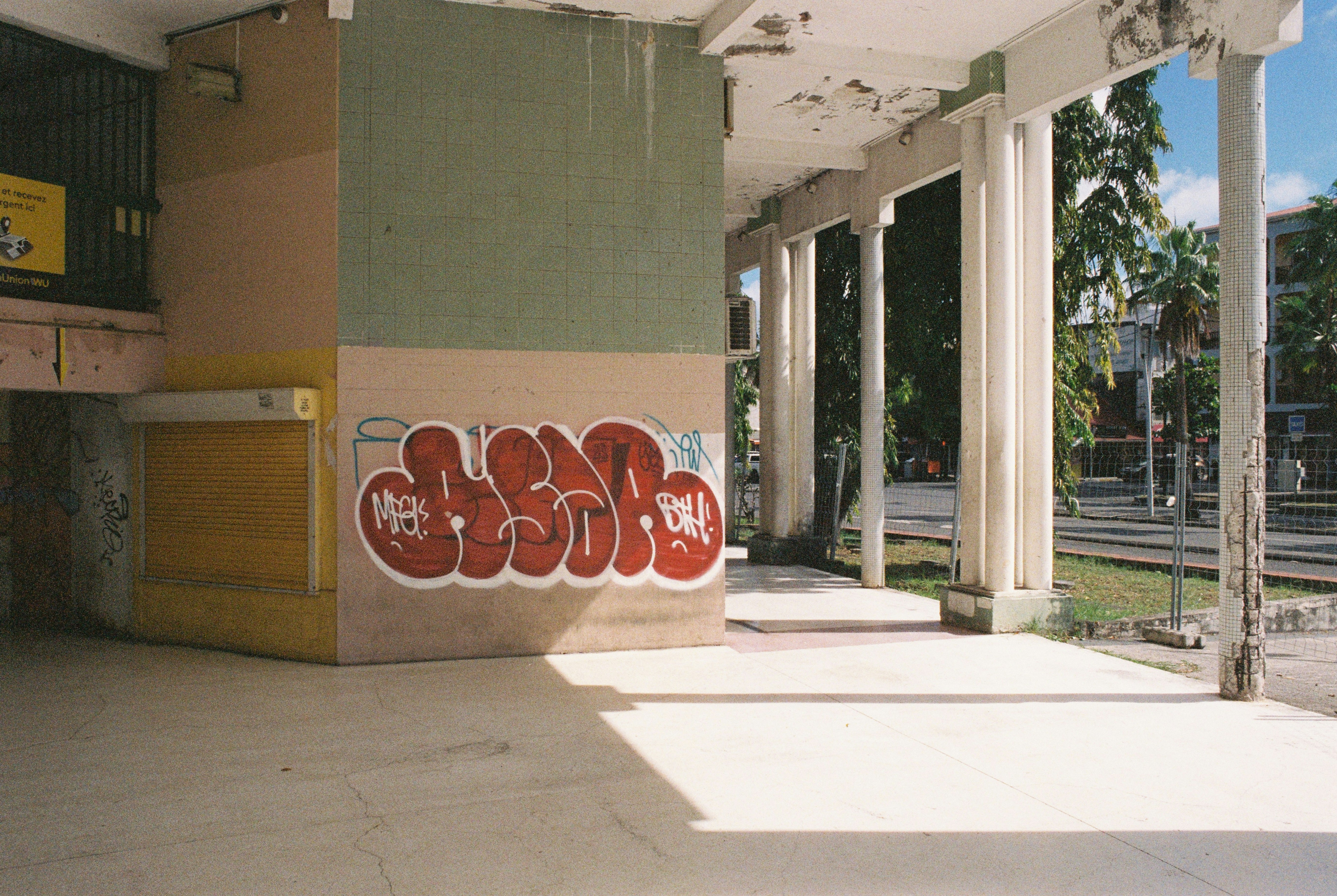 Graffiti decorates a building's exterior.
