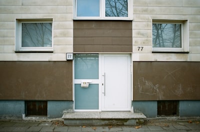 A front door and windows of a building.