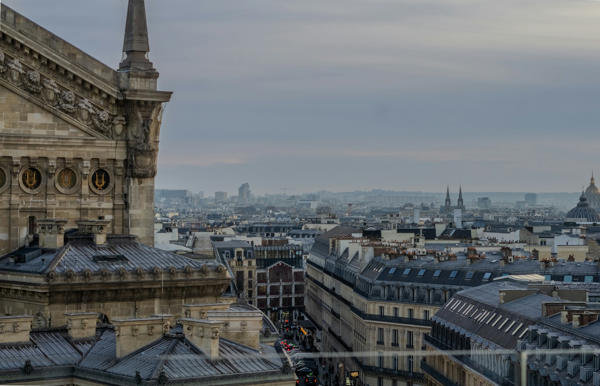 Rooftop view of paris on a cloudy day.