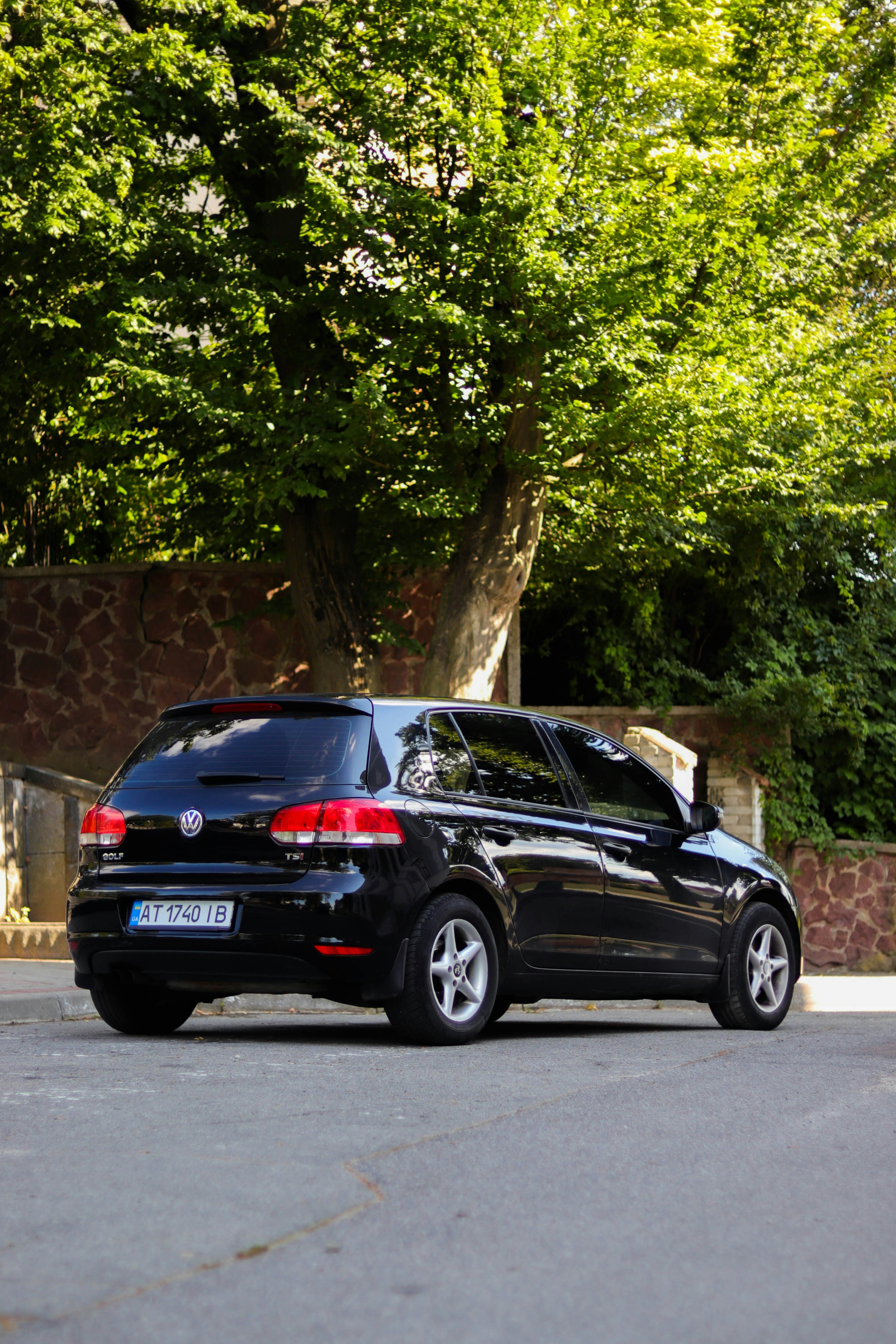 A black volkswagen golf parked on a street.