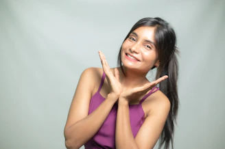 Woman happily poses with her hands.