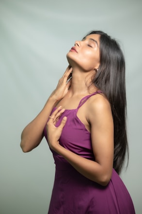 A woman poses with her eyes closed.