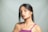 A woman poses looking directly at the camera.