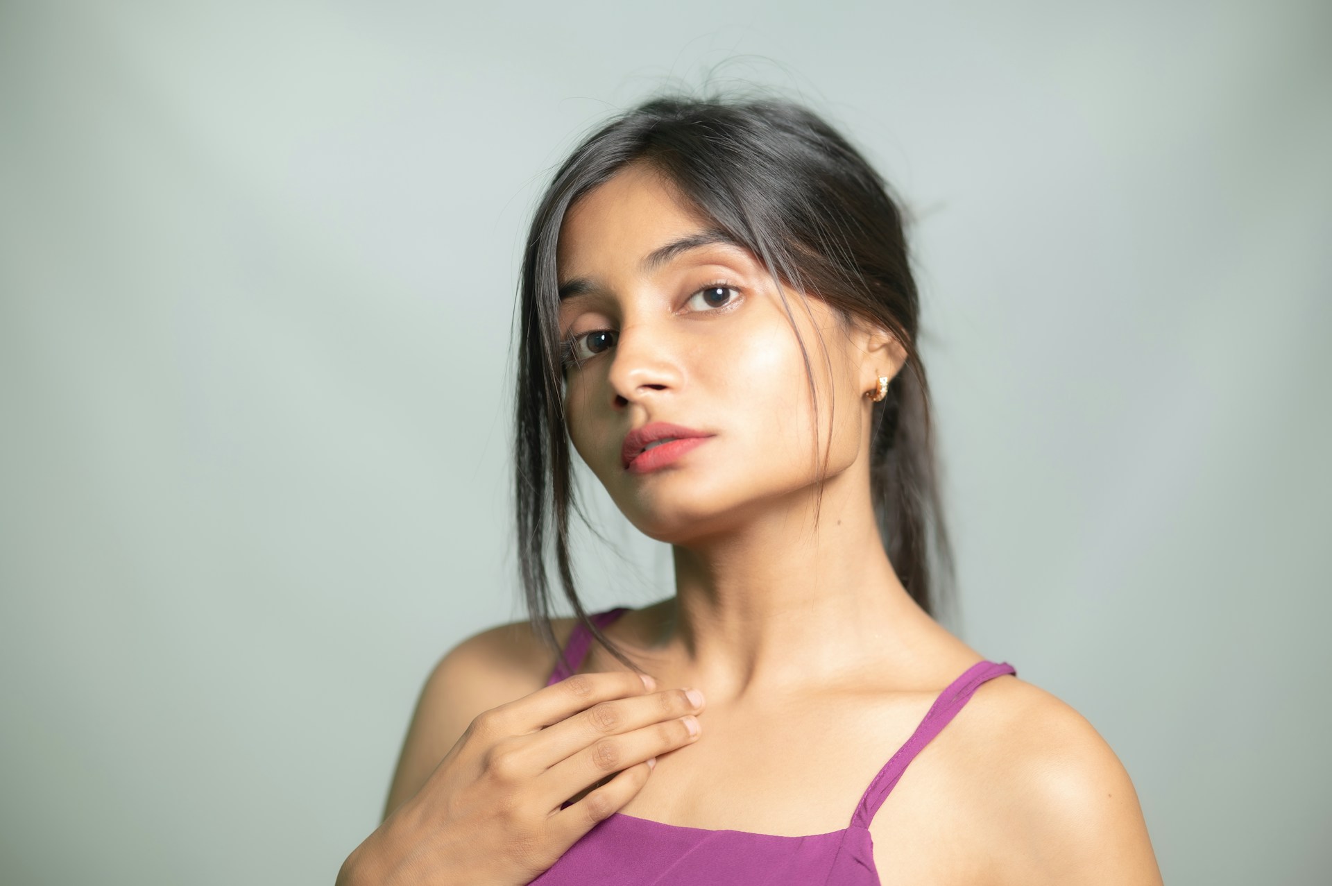 A woman poses looking directly at the camera.