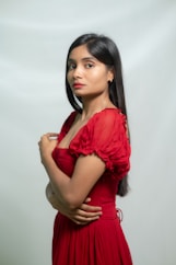 Woman in red dress poses for a photo.