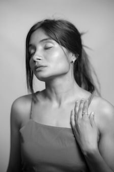 A woman meditates with her eyes closed.