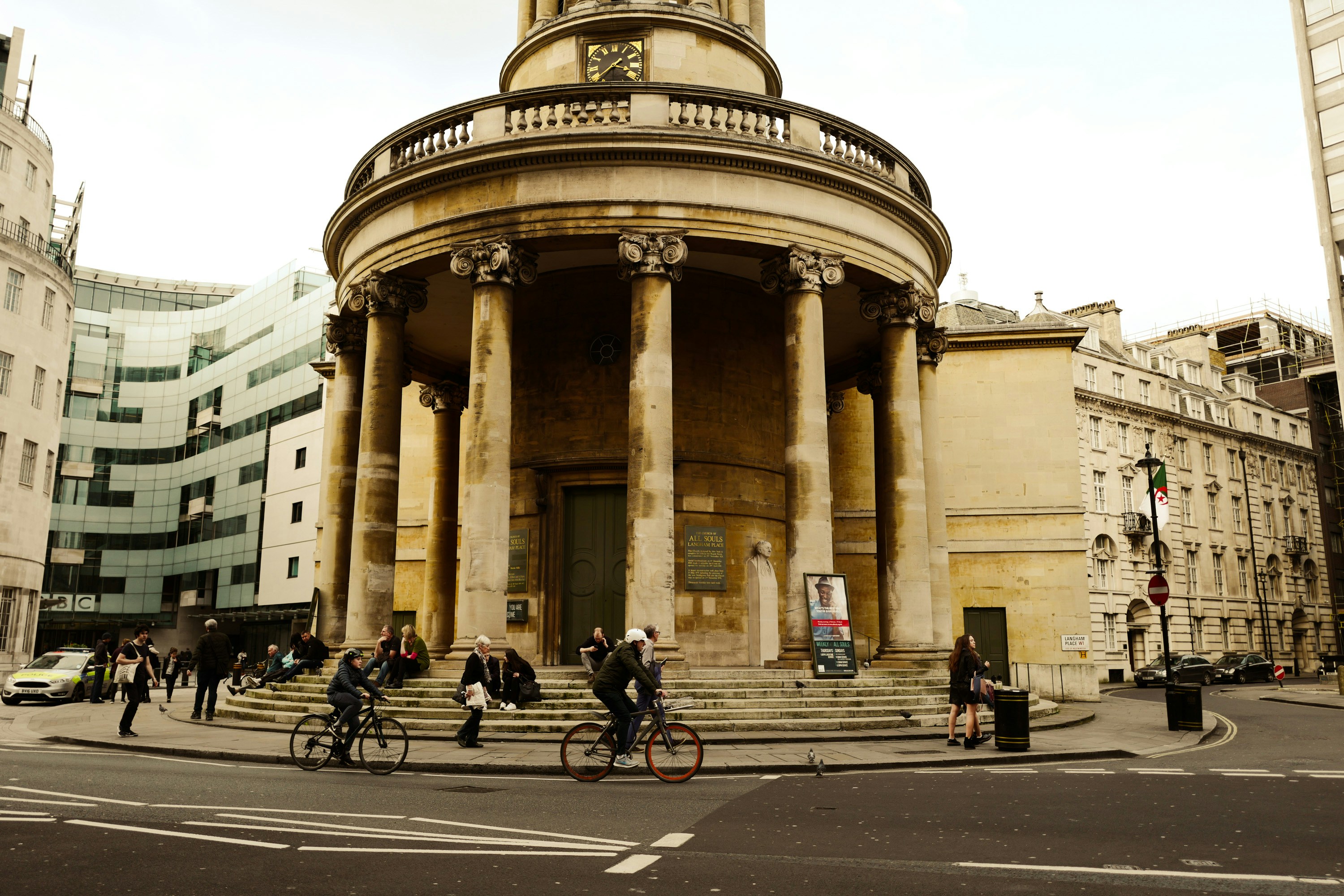 People are near a large, classical building.