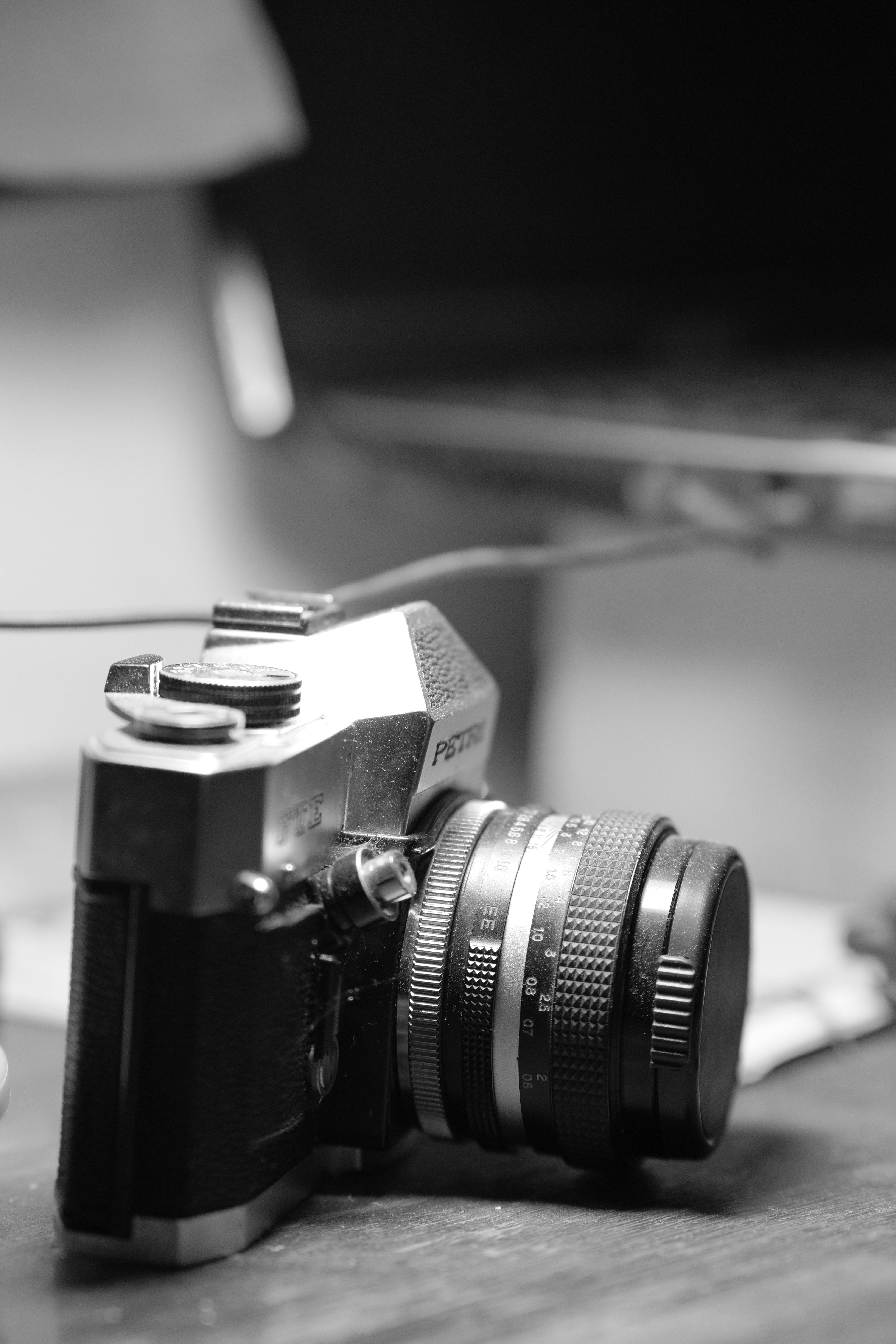 A classic camera is shown in black and white.