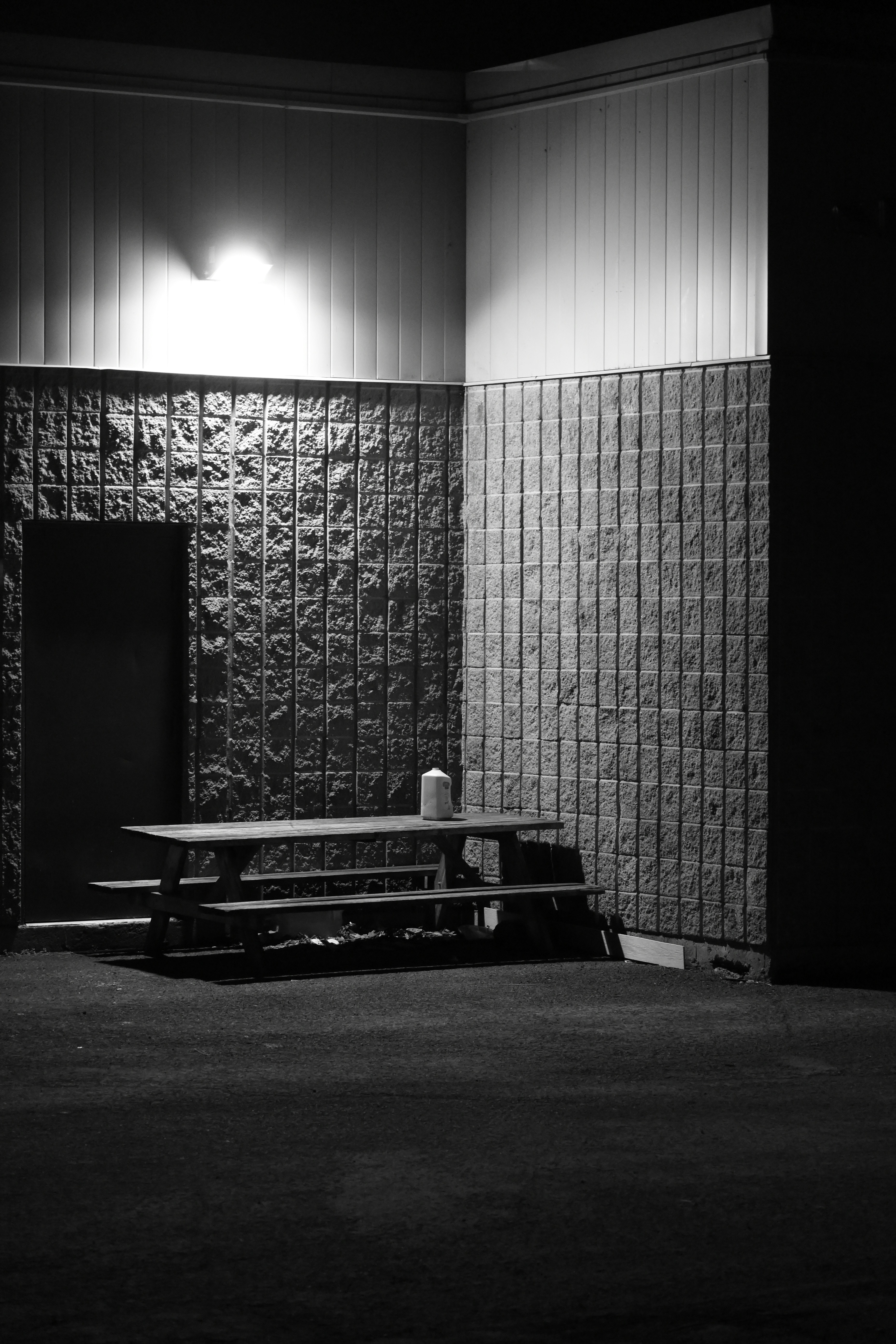 A picnic table sits outside, illuminated at night.
