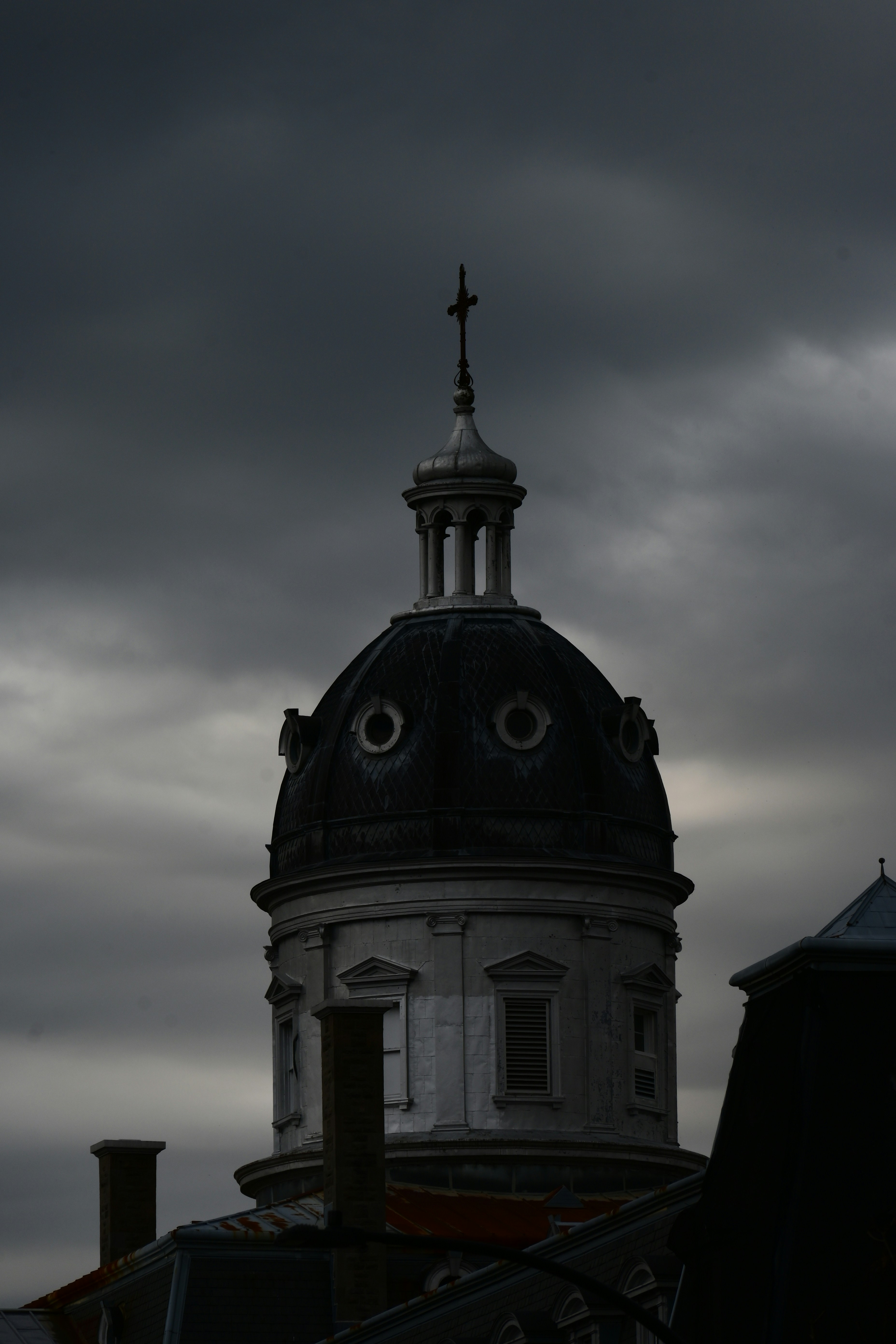 Gothic dome silhouetted against a stormy sky.