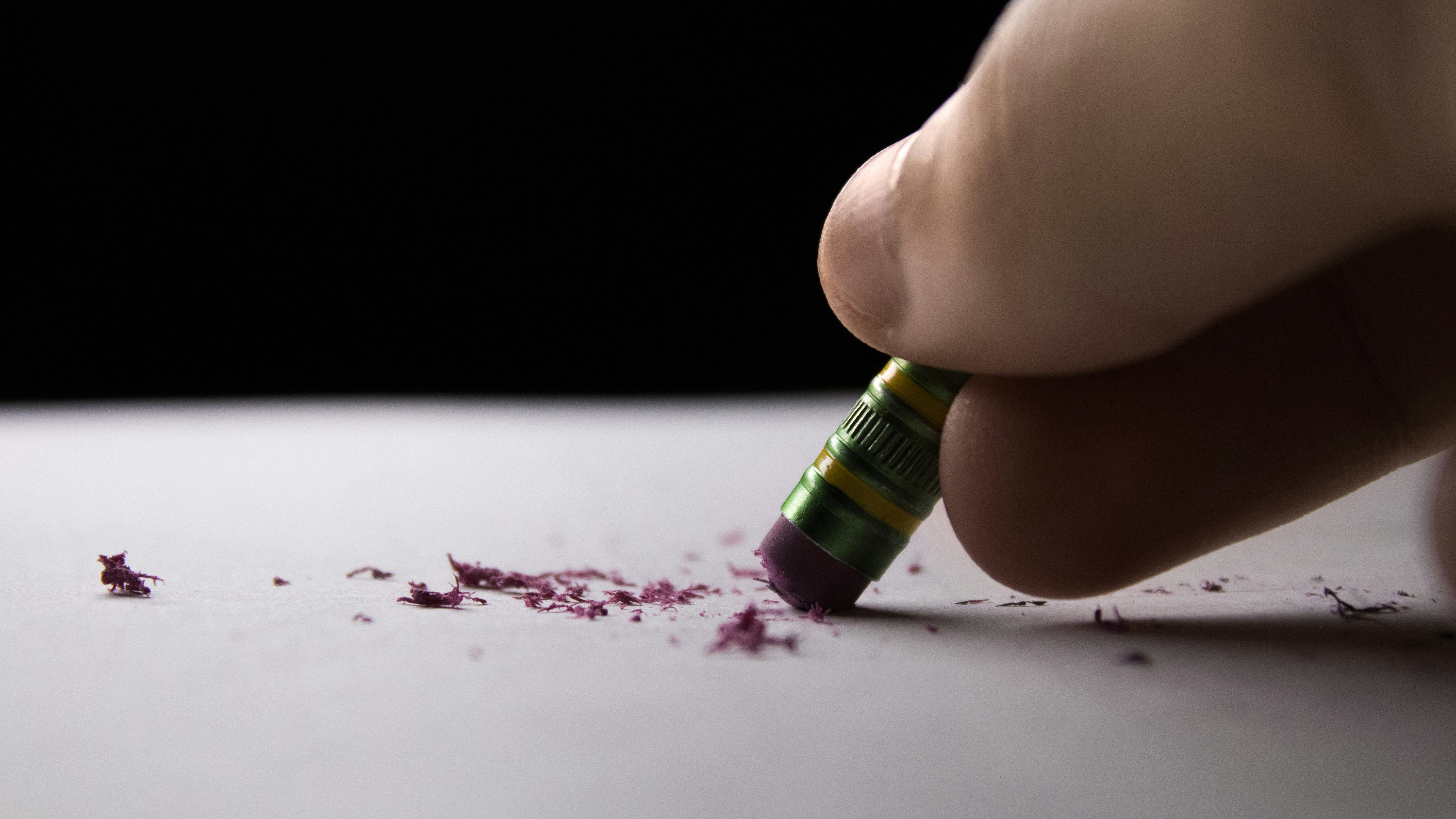 A pencil eraser rubs away pencil marks.