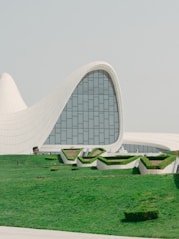 A modern building with greenery and a white exterior.