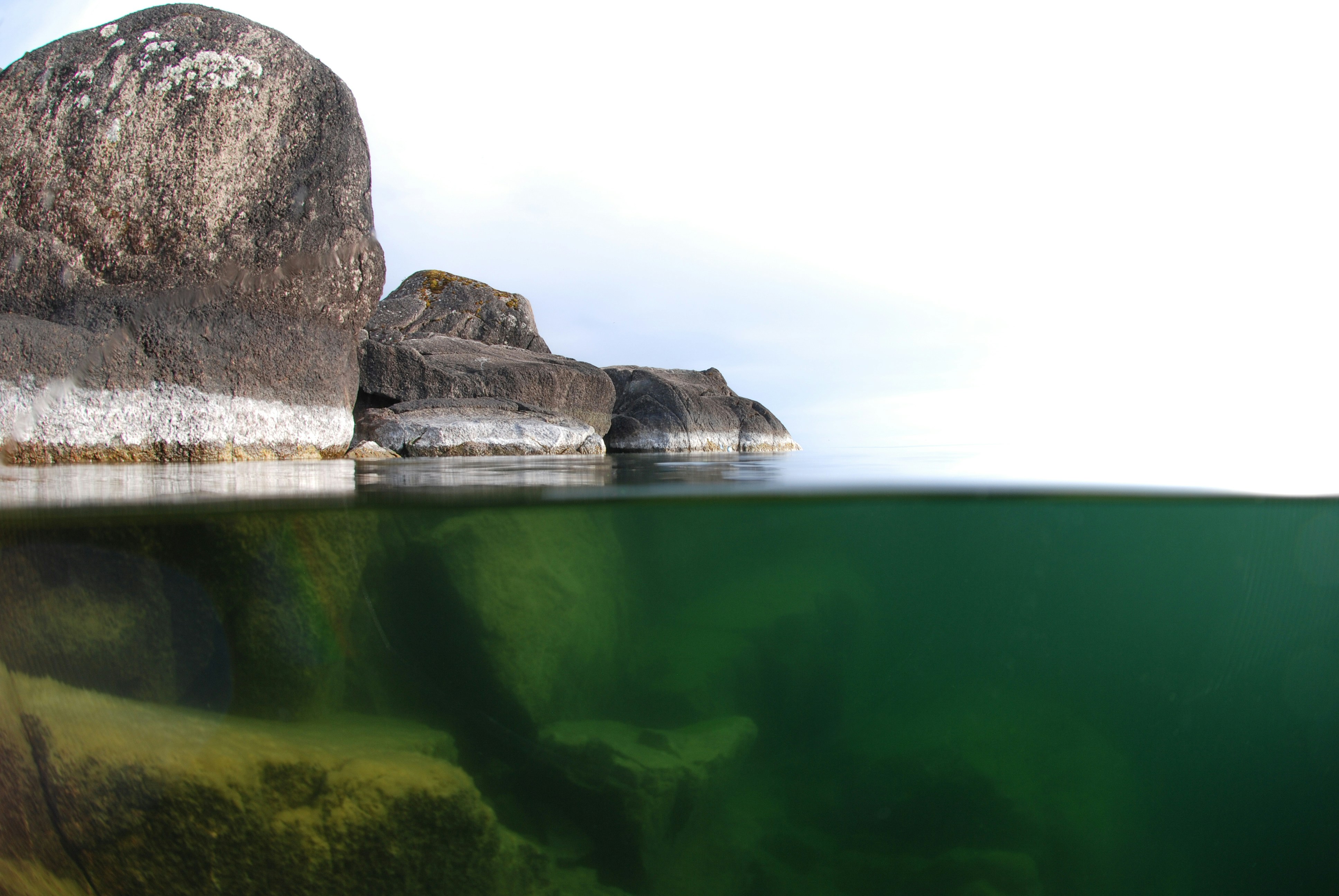 Rocks meet water in a unique split-screen view. photo – Free Underwater ...