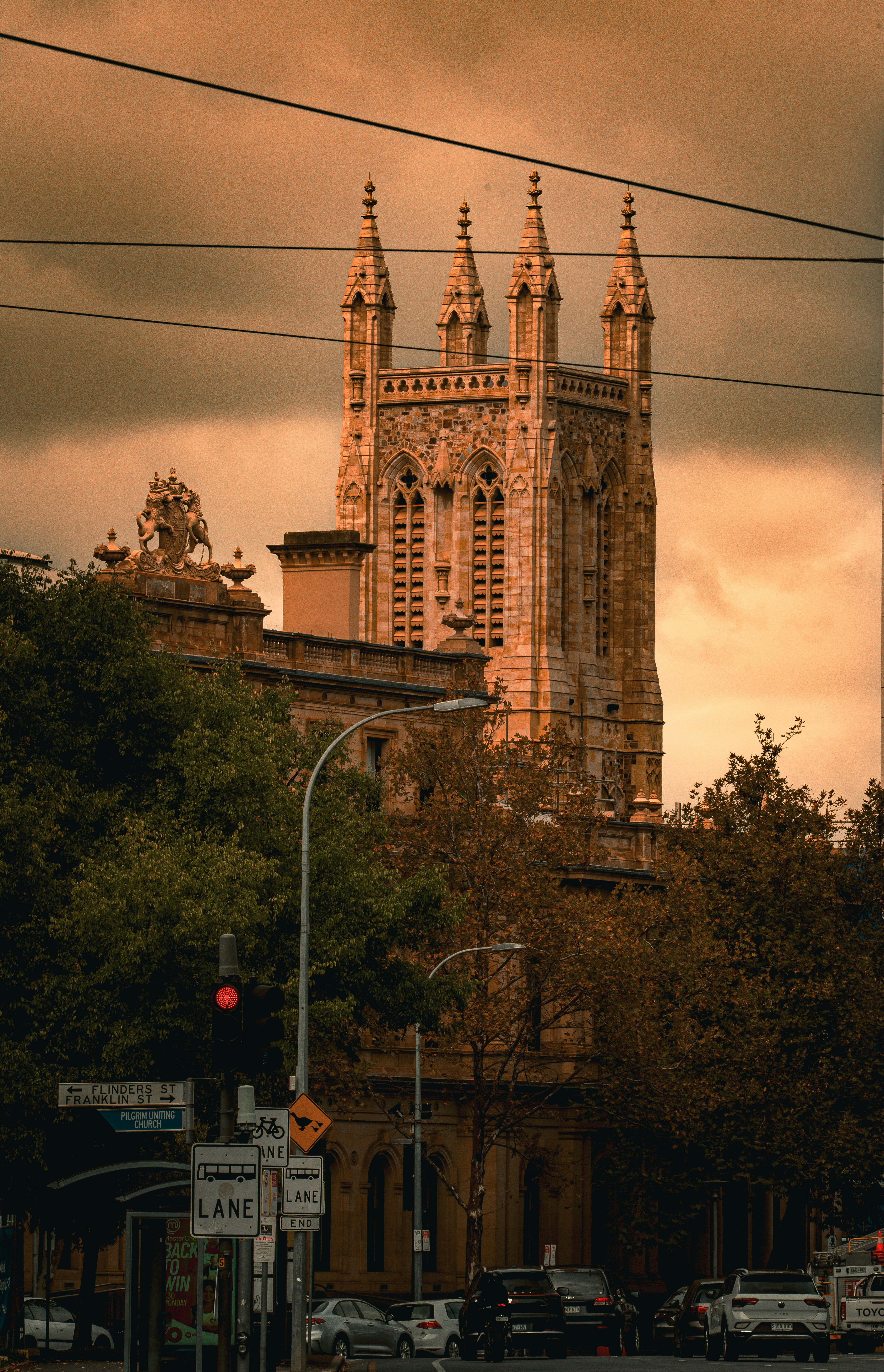 An ornate church tower in a city street.