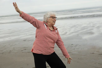 Woman practices tai chi on the beach