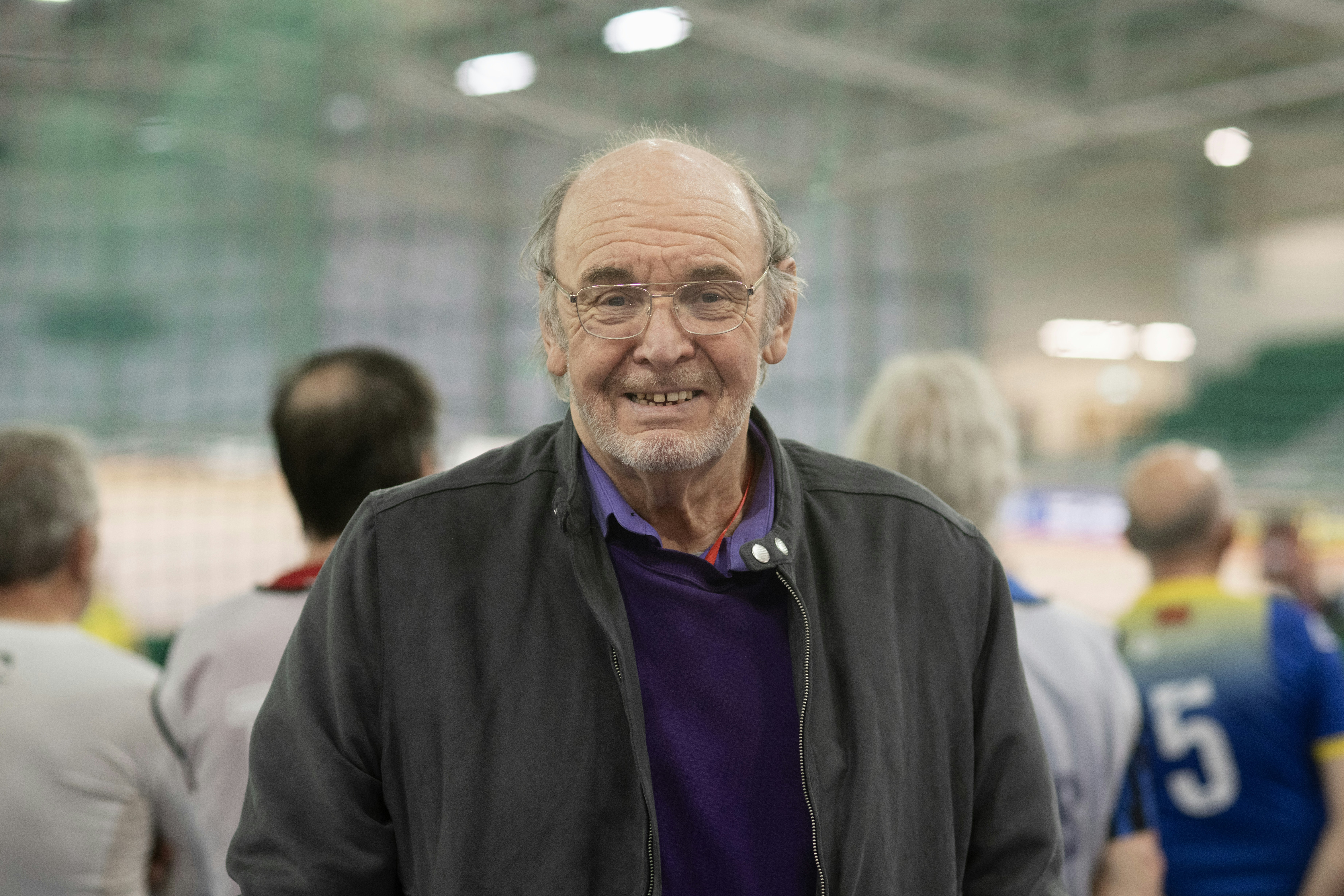 A smiling man poses for a photo.