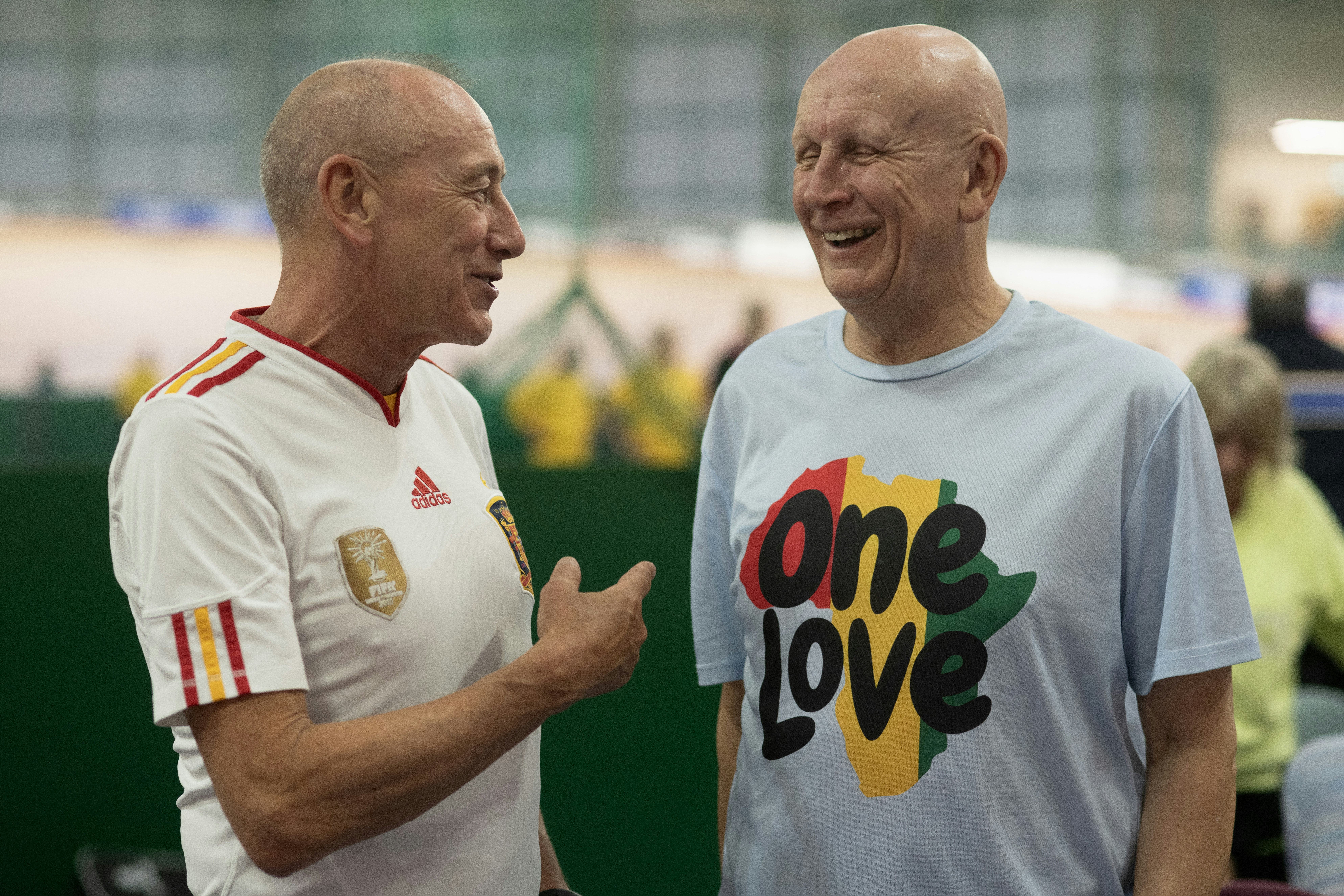 Two men engage in friendly conversation.