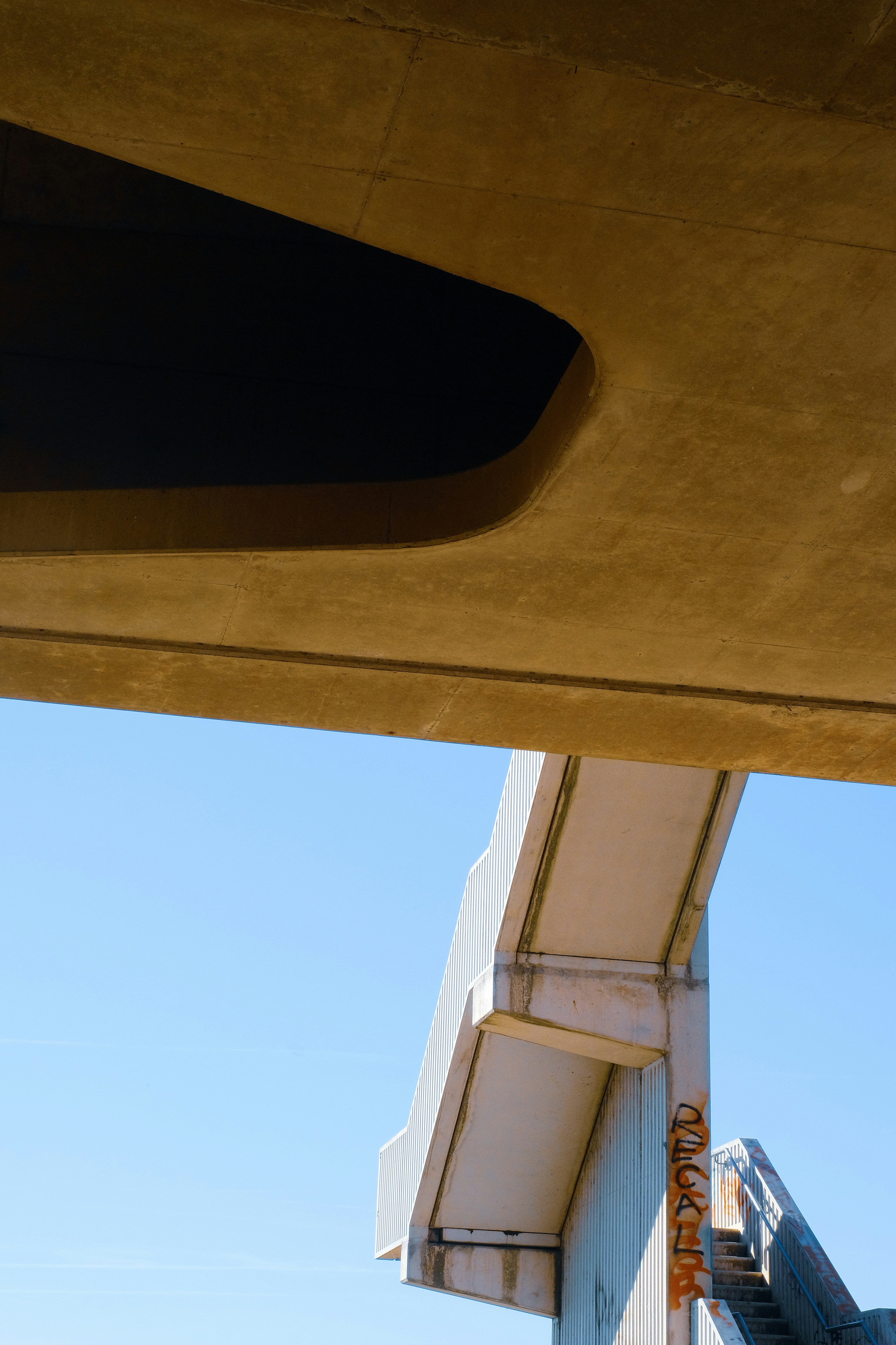 Concrete structures contrast against the blue sky.