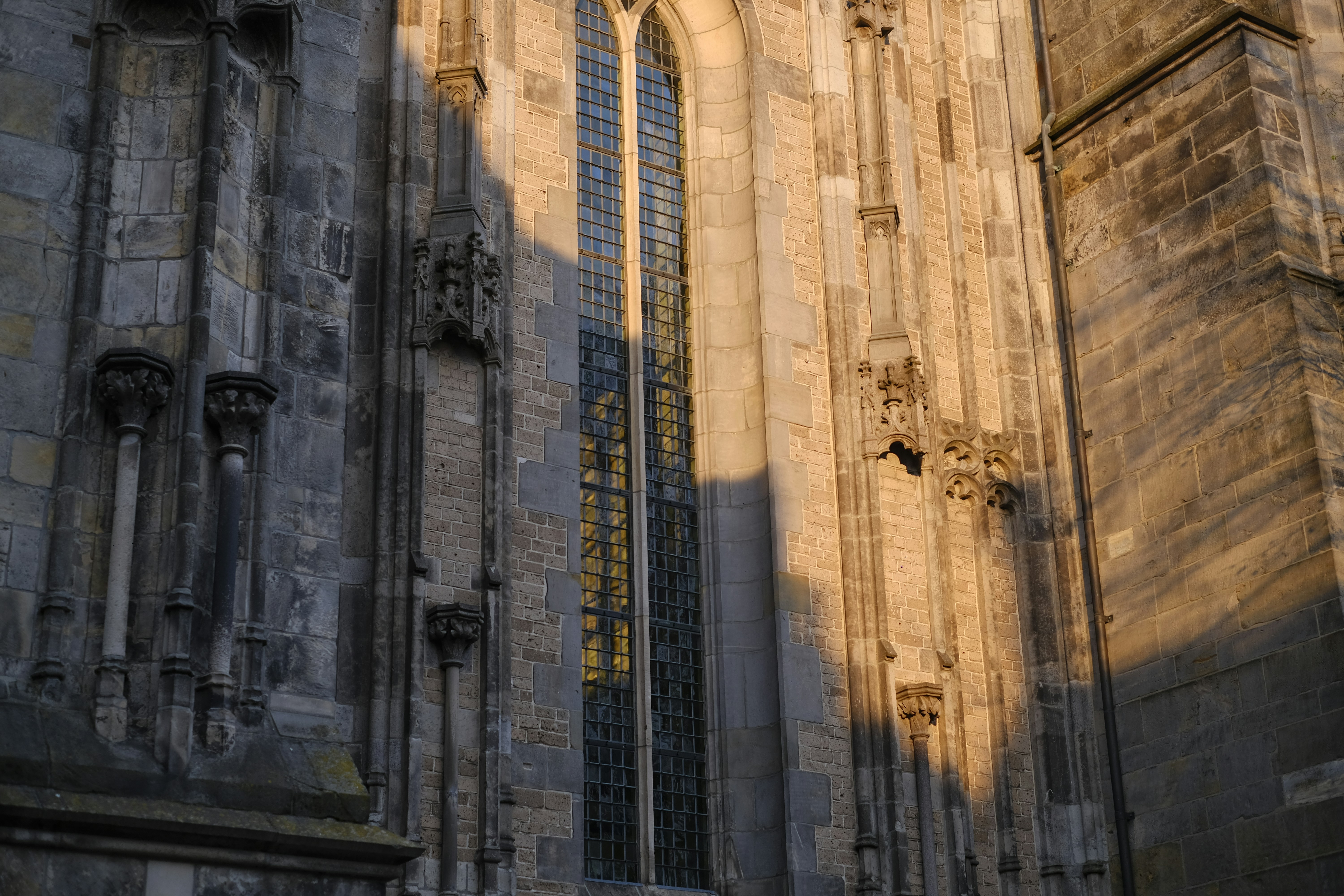 Exterior of a stone building with tall, narrow windows.