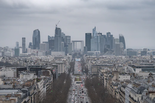 A cityscape of paris under a cloudy sky.