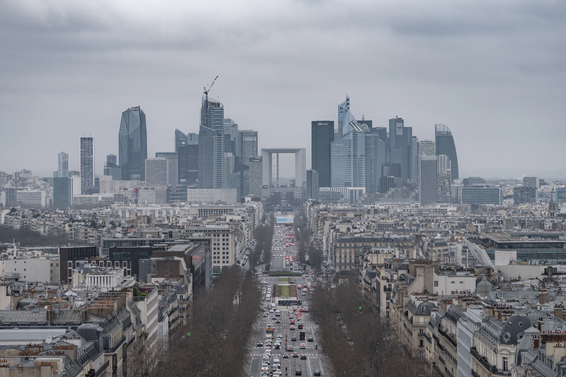 A cityscape of paris under a cloudy sky.