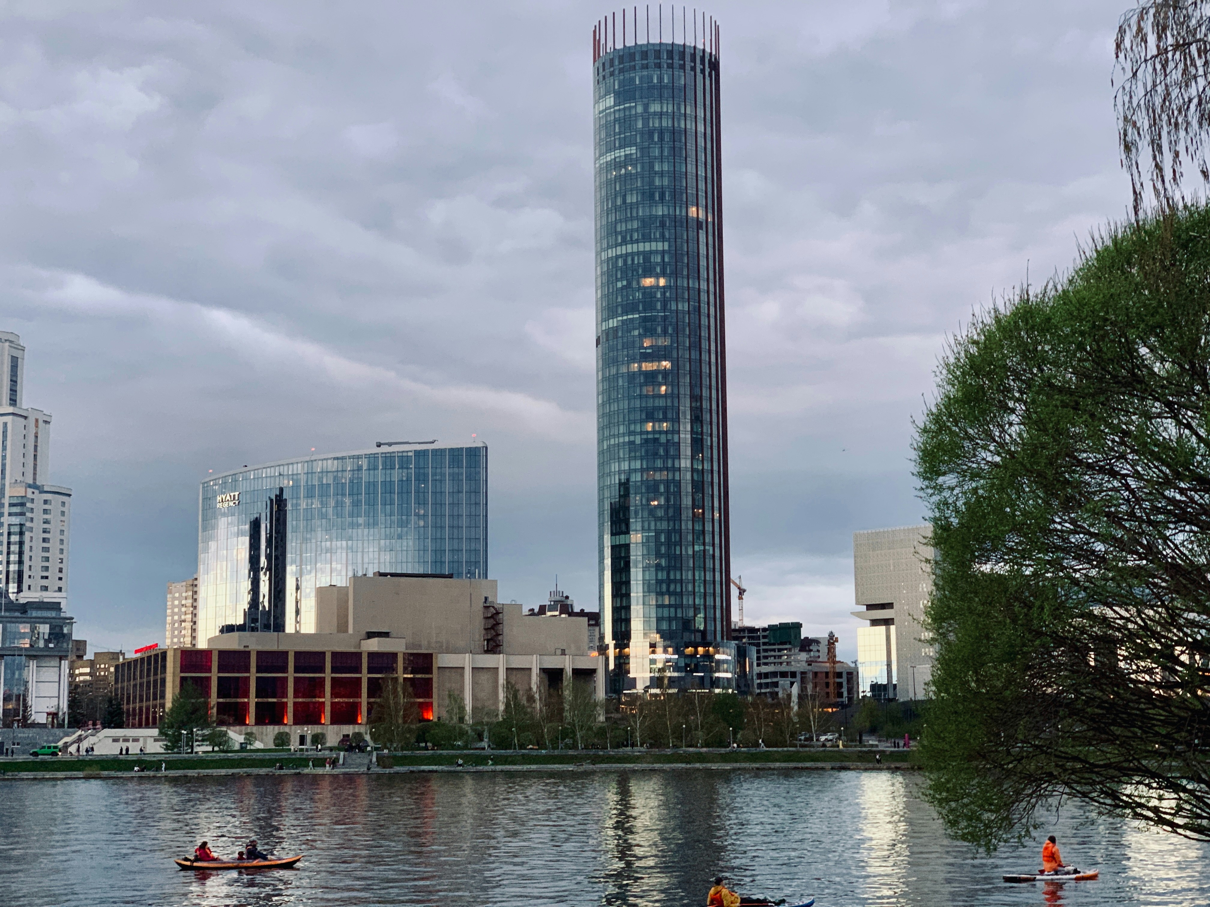 City skyline with tall buildings reflected in the water.