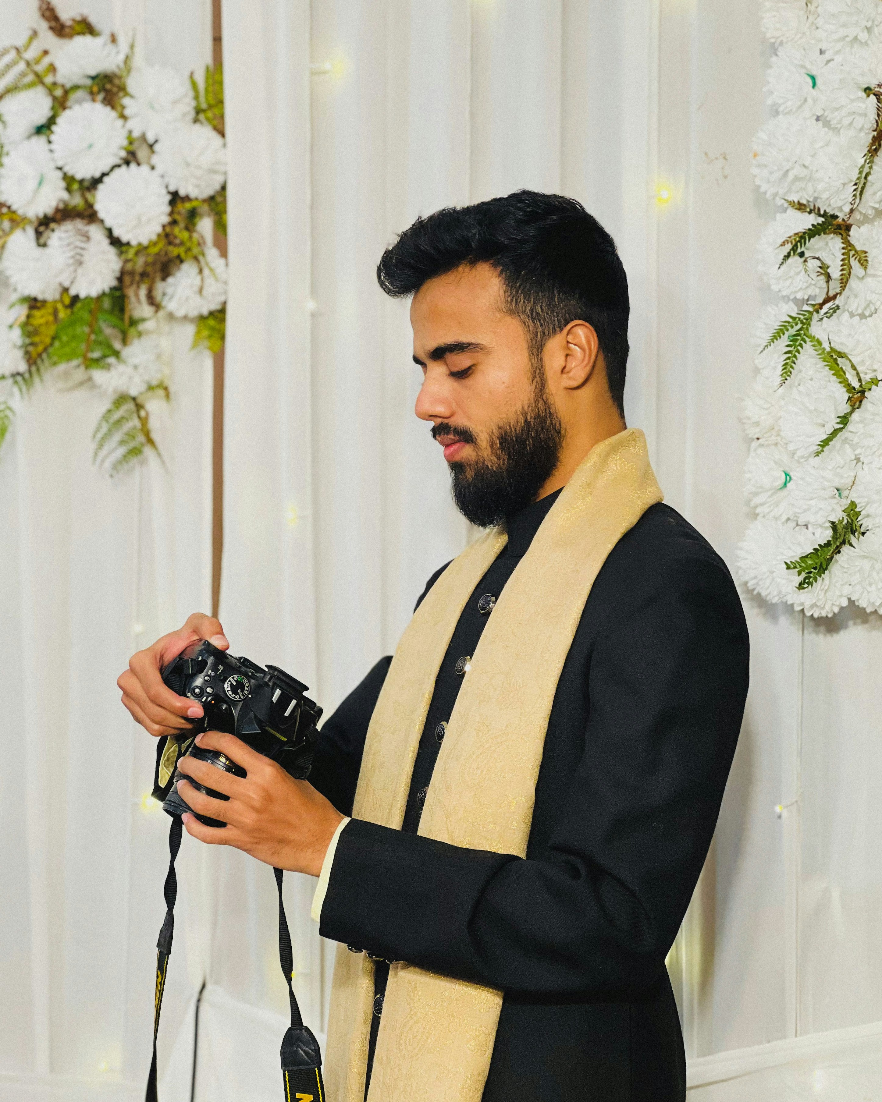 A man is holding a camera, preparing to photograph.