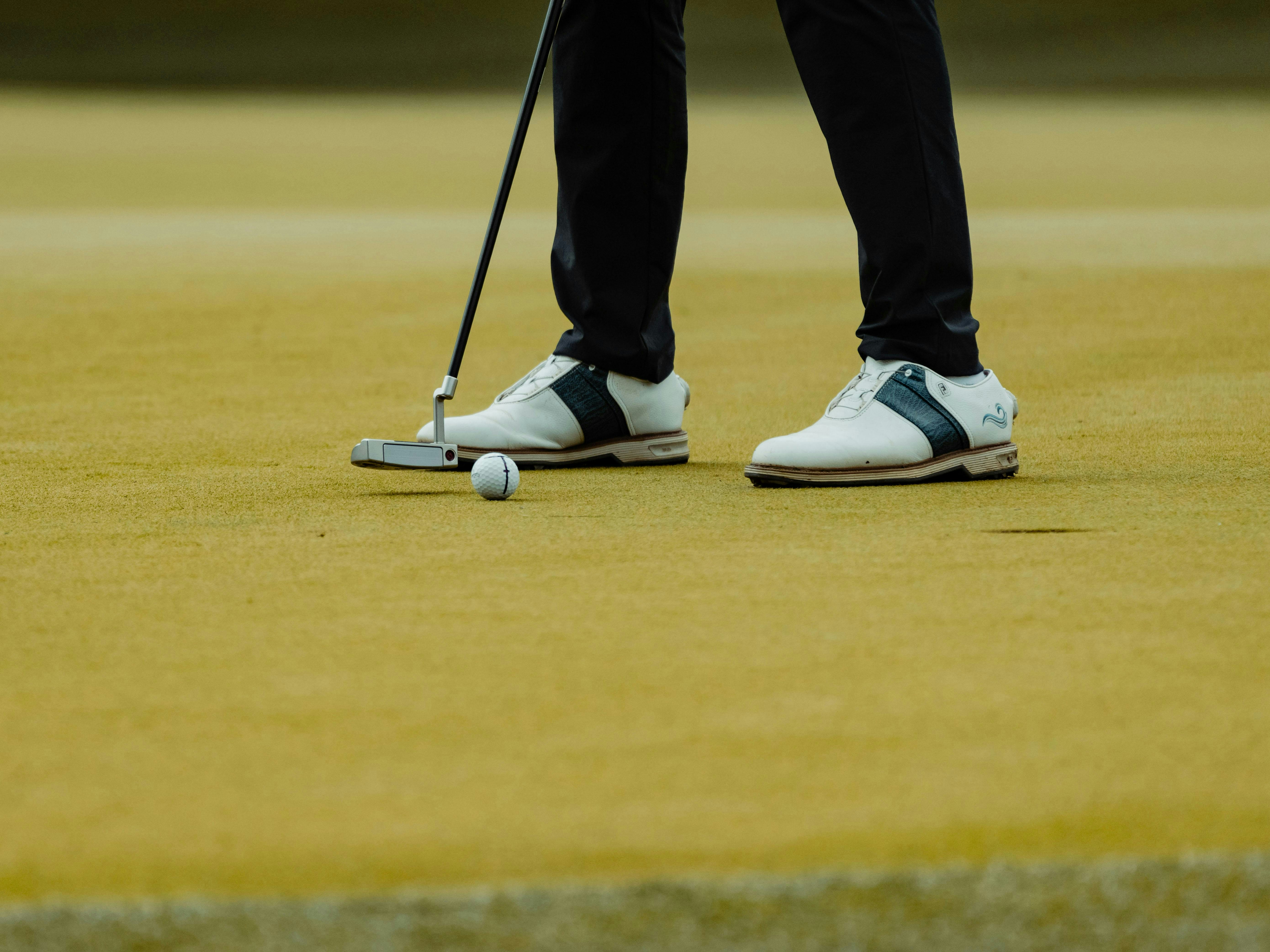 A golfer is about to putt.