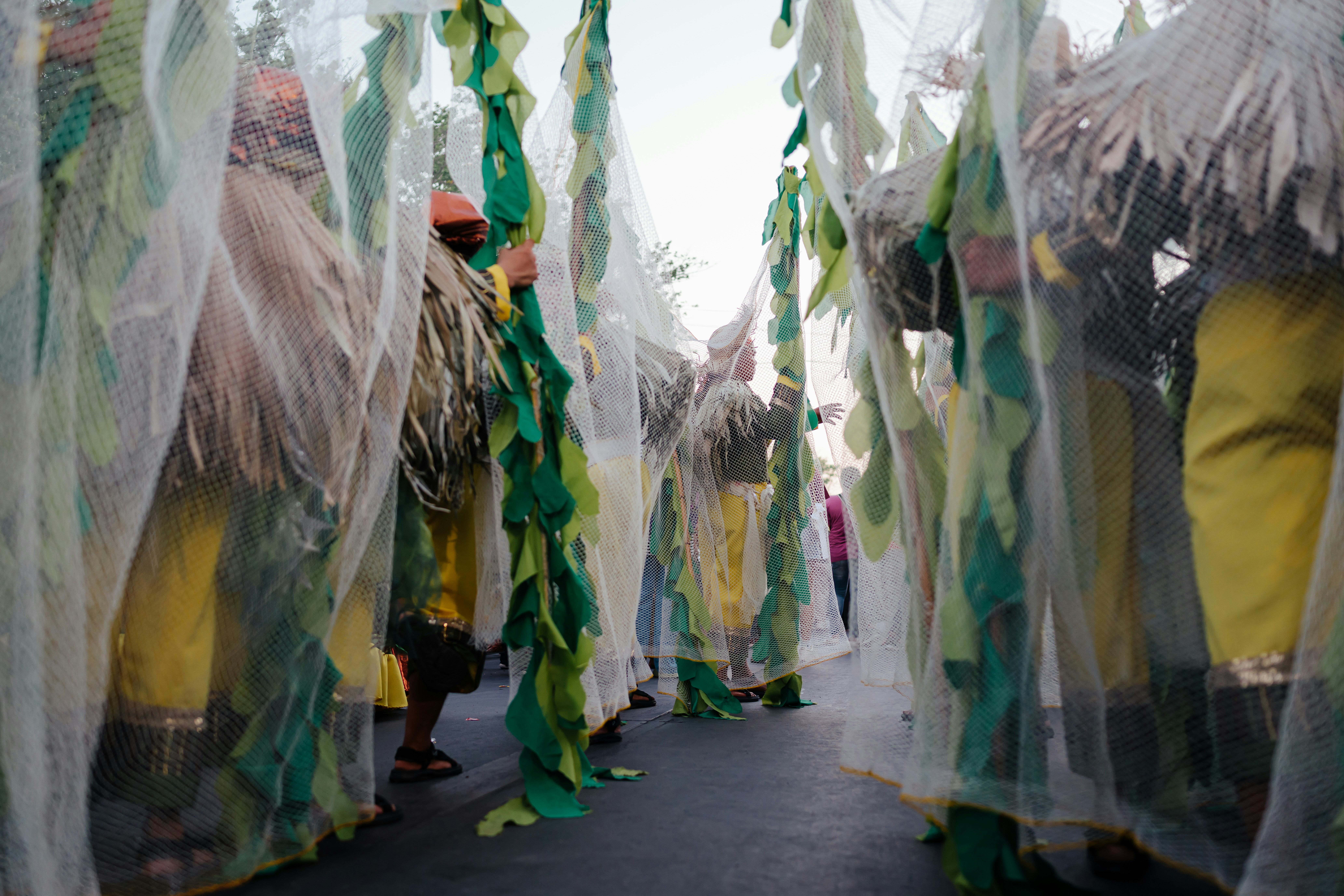 People in costumes are walking through decorations.