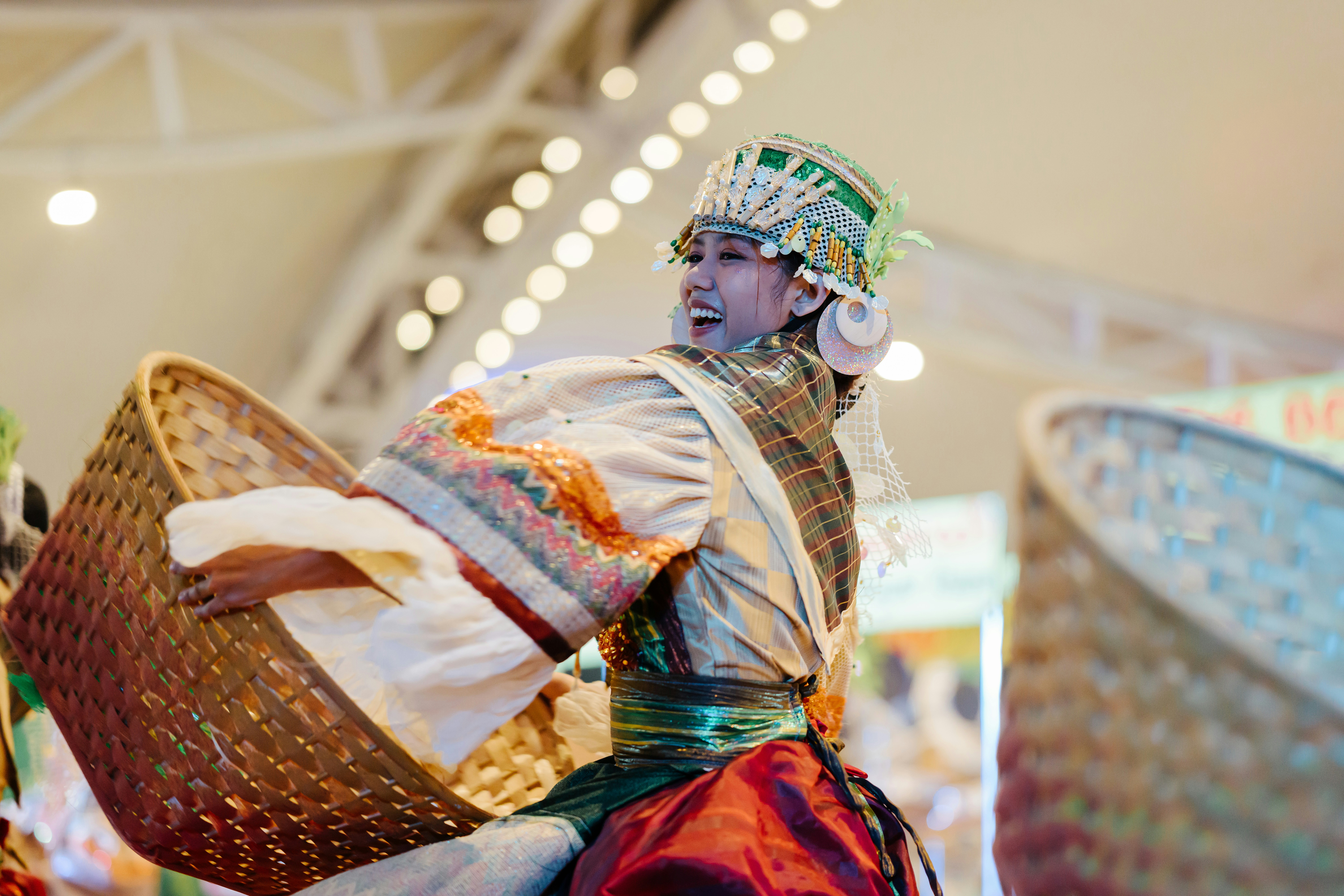 A person dances in traditional costume with a basket.