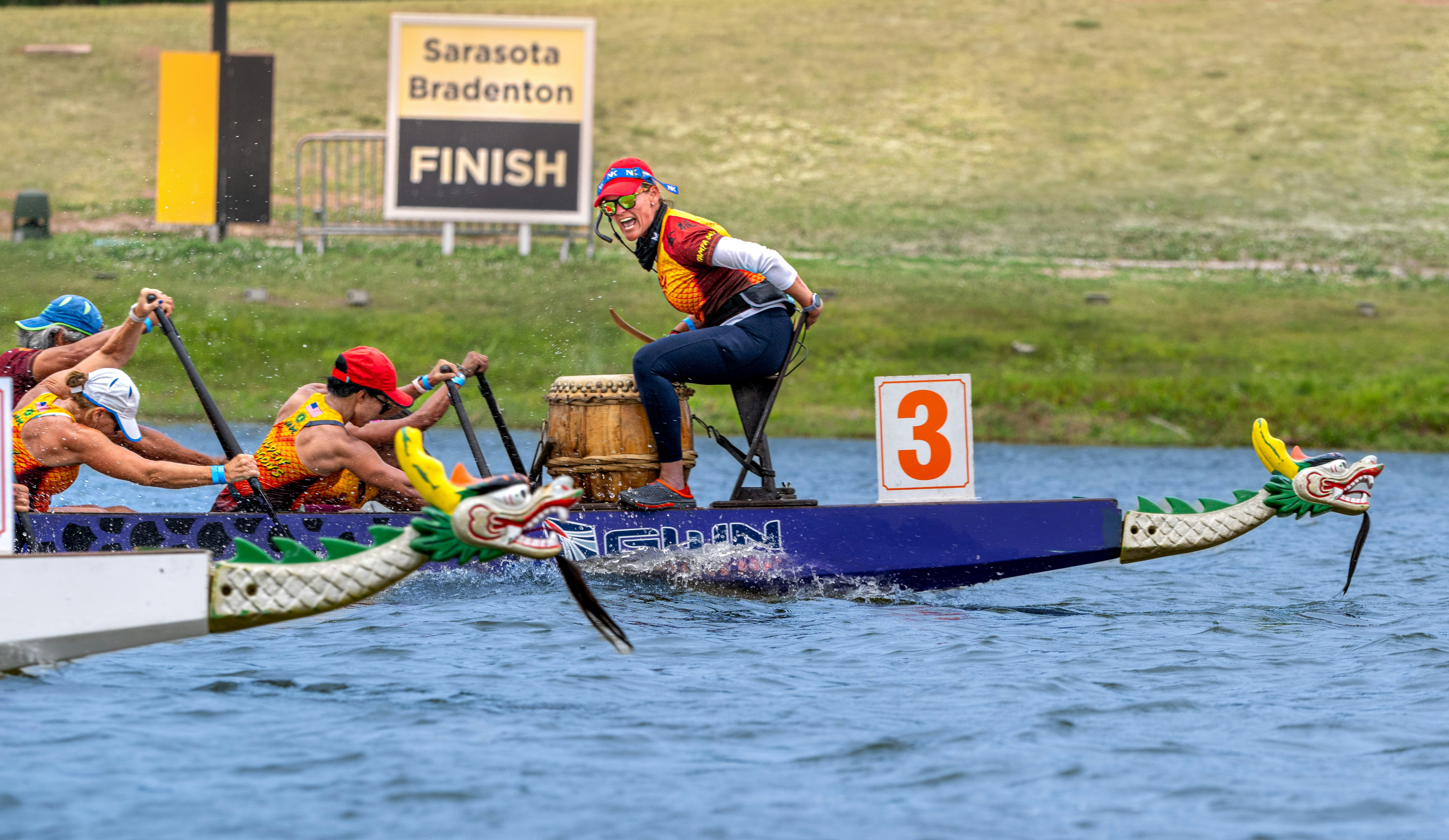 Dragon boat racers compete toward the finish line.